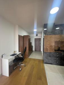 an office with a desk and a chair in a room at Apartment Lazar in Skopje