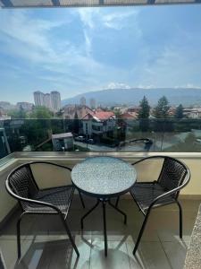 a table and two chairs on a balcony with a view at Apartment Lazar in Skopje