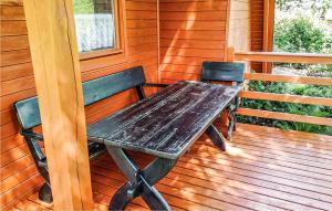 a wooden table and two chairs on a porch at Beautiful Home In Kartuzy With Kitchen in Kartuzy