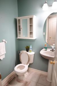 a bathroom with a toilet and a sink at Whitby Private Rooms in Whitby