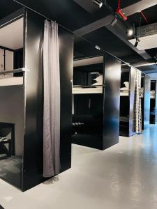 a room with black cabinets with white curtains at 7 Wonders Hostel @ Boat Quay in Singapore