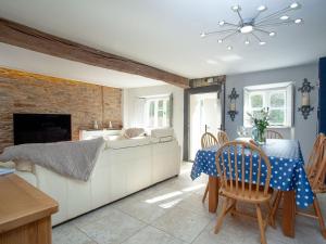 a living room with a table and a couch at The Barn House in Ugborough