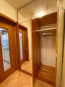 a room with a walk in closet and a mirror at Lovely & quiet 1-bedroom condo with free parking in Bucharest