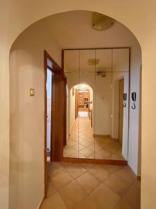 a hallway with a large mirror in a house at Lovely & quiet 1-bedroom condo with free parking in Bucharest