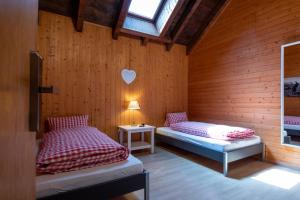 a room with two beds and a heart on the wall at Berghotel Chäserstatt in Ernen