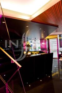 a bar in a room with purple and pink lighting at Hotel Inffinit in Vigo