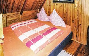 a bedroom with a bed with two pillows on it at Holiday Home Lidzbark Warminski Klebowo in Blanki