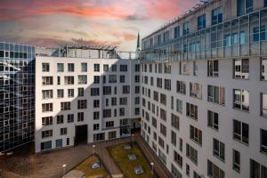 a view of a building with a sunset in the background at Riverside Design Apartment with underground private parking in Rīga