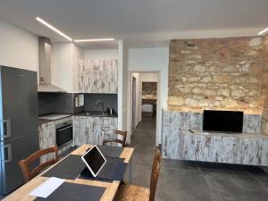 a kitchen with a table with a laptop on it at Piano Terra in Ancona