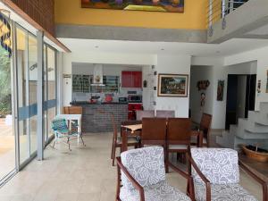 a dining room and kitchen with a table and chairs at Casa Areca in Anapoima