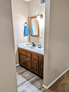 a bathroom with a sink and a mirror at Mountain Views Near Sedona with Fenced Backyard in Cottonwood