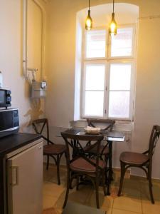 a kitchen with a table and chairs and a window at Szeged-Vár in Szeged