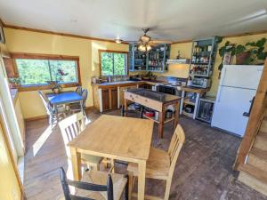 a kitchen with a table and chairs and a refrigerator at Jackass Hostel in North Fork