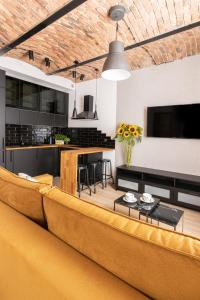 a living room with a couch and a table at KOBIELA Luxury Aparthotel KTW City Center in Katowice
