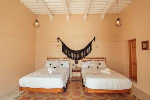 Postel nebo postele na pokoji v ubytování Hotel Casa Piedad