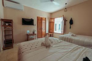 Postel nebo postele na pokoji v ubytování Hotel Casa Piedad