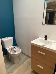 a bathroom with a toilet and a sink at Chambre avec spa privatif in Amiens