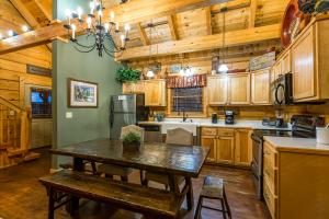 a kitchen with wooden cabinets and a table in a room at McCormack's Mill in Pigeon Forge