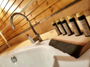 a bathroom with three bottles of soap on a sink at Tölgyes Menedék 2. in Noszvaj