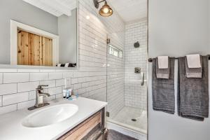 a white bathroom with a sink and a shower at The Historic West Walker Motel in Walker