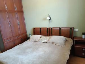 a bedroom with a bed with a wooden head board at Bakuriani-Otin in Bakuriani +7 photos