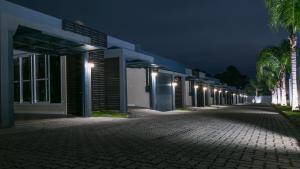 an empty street with a row of buildings at night at Bangalô Motel by Drops in Santa Maria