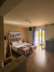 a bedroom with a large bed and a balcony at Little Sea Stars, Tivat in Tivat
