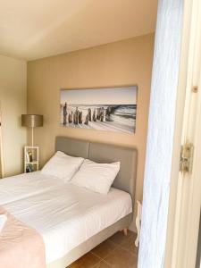 a bedroom with a bed and a picture of a beach at Little Sea Stars, Tivat in Tivat
