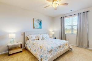 a bedroom with a bed and a ceiling fan at Millville by the Sea --- 36603 Calm Water Drive in Millville +48 photos