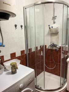a shower with a glass door in a kitchen at Little Sea Stars, Tivat in Tivat