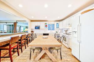 a kitchen with a wooden table and chairs at Newport Beach Front View I in Newport Beach