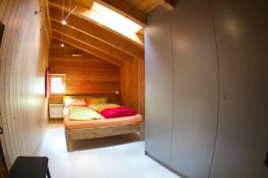 a bedroom with a bed in a wooden cabin at Geburtshaus Prior Siegen in Blatten