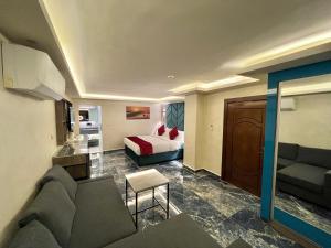 a living room with a couch and a bed at Petra Sella Hotel in Wadi Musa