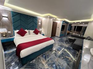 a bedroom with a large bed and a living room at Petra Sella Hotel in Wadi Musa