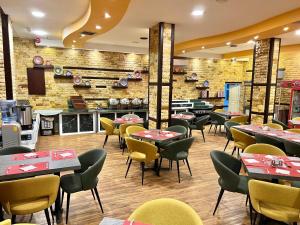 a restaurant with tables and chairs in a room at Petra Sella Hotel in Wadi Musa