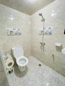 a bathroom with a toilet and a shower at darna surf house anza in Agadir