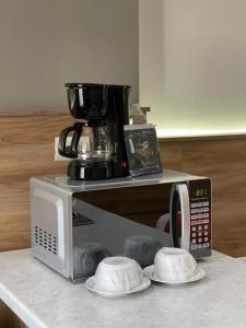 een koffiezetapparaat bovenop een magnetron bij HOTEL LOS ROBLES in Nuevo Laredo