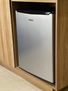 a white dishwasher in a cabinet in a kitchen at HOTEL LOS ROBLES in Nuevo Laredo