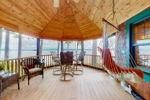 a porch with a hammock and a swing at Alton Bay Lakefront Beauty in Alton Bay