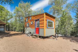 a tiny house sitting on top of a dirt lot at NEW Lovable Mountain Tiny Home near Cripple Creek in Cripple Creek