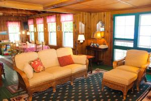 a living room with a couch and two chairs at Cottage on Geneva Point in Moultonborough +30 photos