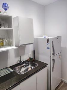 a kitchen with a sink and a refrigerator at DEPARTAMENTO MONO AMBIENTE in Reconquista