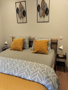 a bed with two pillows on it in a room at Theressa - Free Wifi en Netflix in Zutendaal