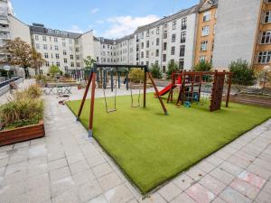 a playground with a swing set in a park at Sanders Stage - Perfectly Planned Three-Bedroom Apartment Near Nyhavn in Copenhagen