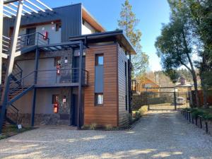 a house with a staircase on the side of it at Alberti Desing in San Carlos de Bariloche