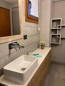 a bathroom with a white sink and a mirror at Alberti Desing in San Carlos de Bariloche +12 photos