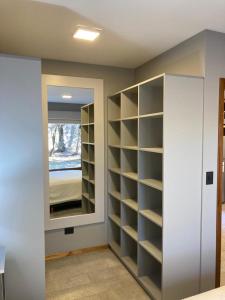 a room with a closet with shelves and a mirror at Alberti Desing in San Carlos de Bariloche