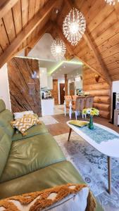 a living room with a couch and a table at Rezydencja Tatry - Apartament Chamerion 1 in Zakopane