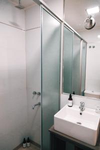 a bathroom with a sink and a shower at 356 Apartments - in Mendoza