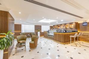 a lobby of a hotel with a bar at Golden Sands Suites in Dubai